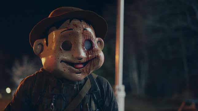 A scary-smiling bloodstained mask in The Conference