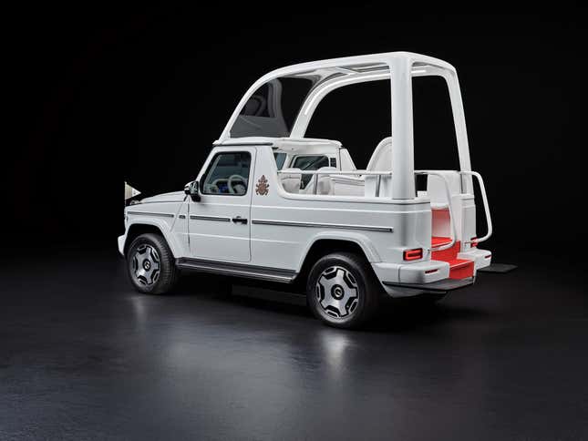 Rear 3/4 view of the white Mercedes-Benz G580 Popemobile