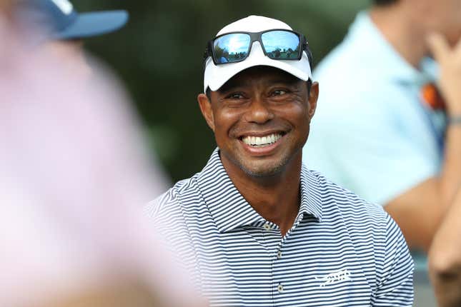 BLOOMFIELD HILLS, MICHIGAN - JULY 22: Tiger Woods of the United States talks with spectators near the putting green on day one of the 76th U.S. Junior Amateur Championship on the North Course at Oakland Hills Country Club on July 22, 2024 in Bloomfield Hills, Michigan. 