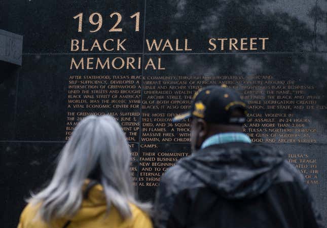 People look at the 1921 Black Wall Street Memorial on the 100 year anniversary of the Greenwood massacre in Tulsa, Oklahoma, on May 31, 2021