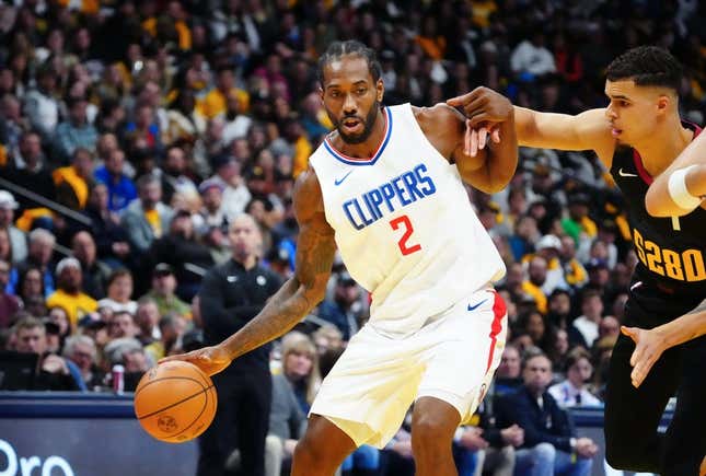 Nov 14, 2023; Denver, Colorado, USA; LA Clippers forward Kawhi Leonard (2) drives to the basket against Denver Nuggets forward Michael Porter Jr. (1) in the second quarter at Ball Arena.