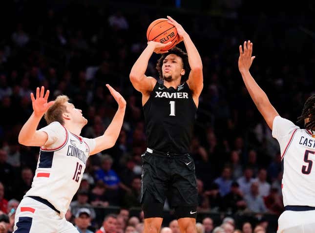 March 14, 2024;  New York, NY, USA;  Xavier Musketeers guard Desmond Claude (1) shoots past Connecticut Huskies guard Cam Spencer (12) during the second half at Madison Square Garden.