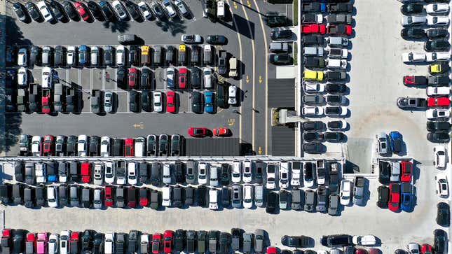 A photo of cars parked on a dealer forecourt. 