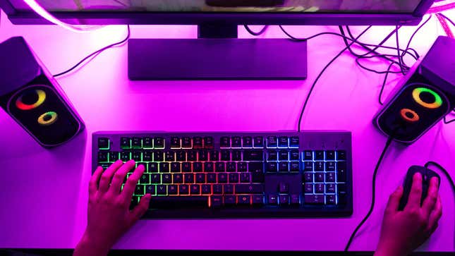 An image of a keyboard and mouse on a pink desk. 