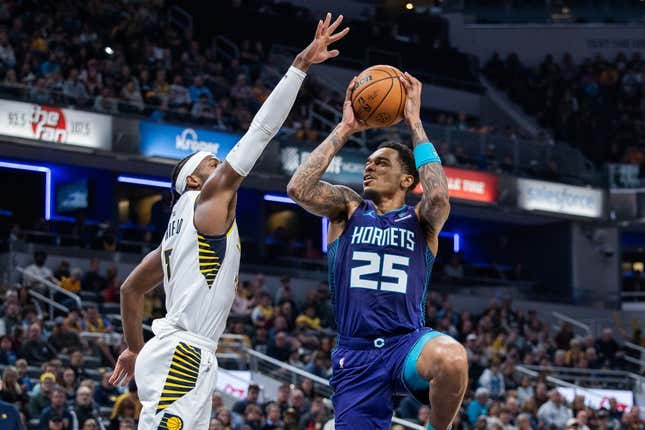 Nov 4, 2023; Indianapolis, Indiana, USA; Charlotte Hornets forward P.J. Washington (25) shoots the ball whileIndiana Pacers guard Buddy Hield (7)  defends in the first half at Gainbridge Fieldhouse.