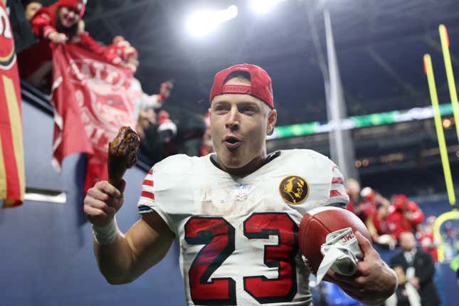 SEATTLE, WASHINGTON - NOVEMBER 23: Christian McCaffrey #23 of the San Francisco 49ers walks off the field eating a turkey leg after beating the Seattle Seahawks 31-13 at Lumen Field on November 23, 2023 in Seattle, Washington. (Photo by Steph Chambers/Getty Images)