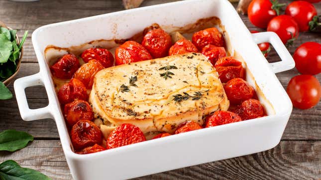 Baking pan filled with feta cheese, tomatoes, and pasta