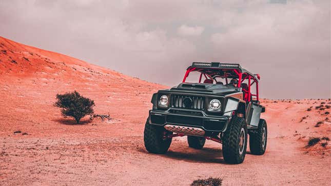 A photo of the Brabus Crawler off-road truck driving in the desert. 