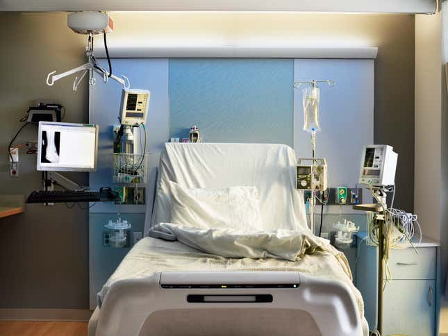 Empty hospital bed with equipment. 