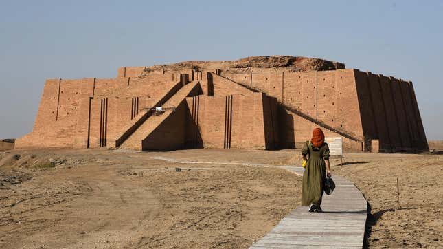 A woman approaches a large Sumerian ziggurat.