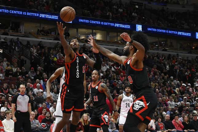 Nov 3, 2023; Chicago, Illinois, USA; Chicago Bulls forward Torrey Craig (13) and guard Coby White (0) chase a rebound against the Brooklyn Nets during the first half at the United Center.