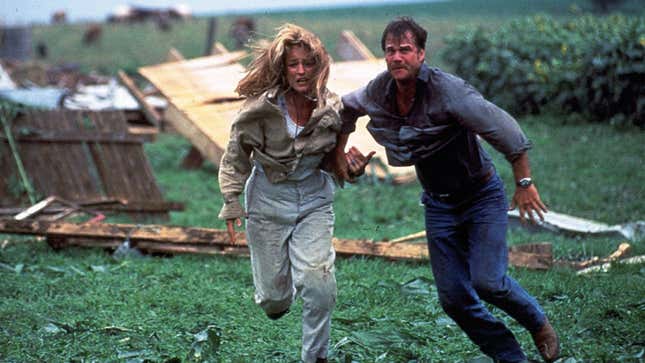 Helen Hunt and Bill Paxton run from a tornado.