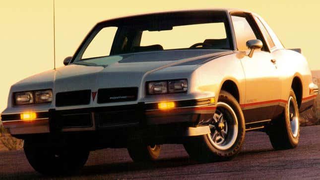 A photo of a silver Pontiac Grand Prix 2+2 sports car. 