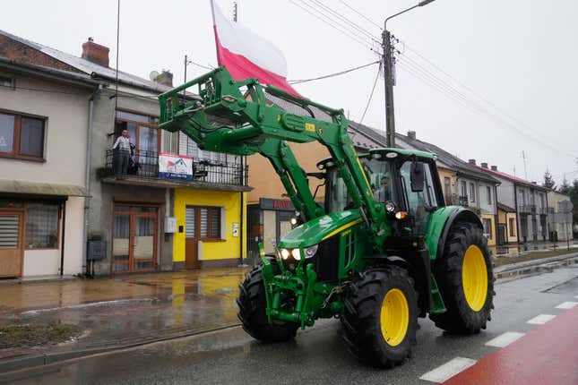 Protesting farmers in Poland are slow-driving their tractors on a road in Deblin, Poland, Wednesday, Jan. 24, 2024 to disturb traffic and draw attention to their disagreement to European Union regulations. Such protests were held across Poland. (AP Photo/Czarek Sokolowski)