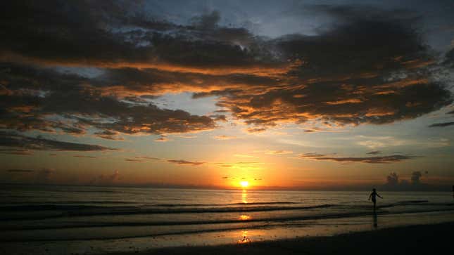 A person walking on the beach during sunset on July 16, 2007 in Marco Island, Florida