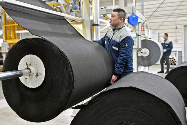 FILE - Workers produce car mats in a factory of car interior pieces in Yantai in east China&#39;s Shandong province on Feb. 21, 2024. China&#39;s manufacturing and investment improved in the first two months of the year, while weakness in the property sector weighed on the economy, the National Bureau of Statistics said Monday, March 18. (Chinatopix via AP, File)