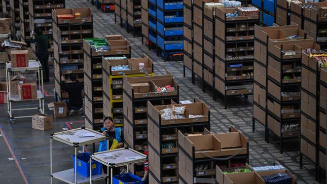 Employees put products in shelves which are then moved by robots in the warehouse of Cainiao Smart Logistics Network, the logistics affiliate of e-commerce giant Alibaba, in Wuxi, China’s eastern Jiangsu province.