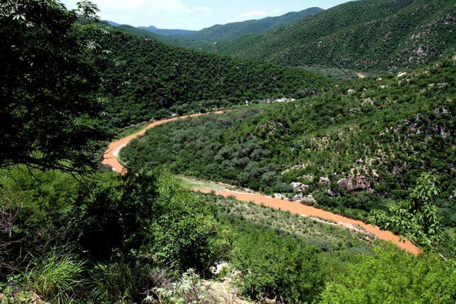 FILE - the Sonora River, contaminated by the spill of about 10 million gallons of copper sulfate and heavy metals from the Buenavista copper mine, makes its way through the hills near the town of Mazocahui in the northern state of Sonora, Mexico, Aug. 12, 2014. Mexico is pursuing a criminal complaint against the country&#39;s biggest copper producer seeking to force a new remediation effort for the toxic mine spill in the northern state of Sonora nine years ago, an environmental official said Thursday, Oct. 12, 2023. (AP Photo/El Imparcial, Julian Ortega, File)