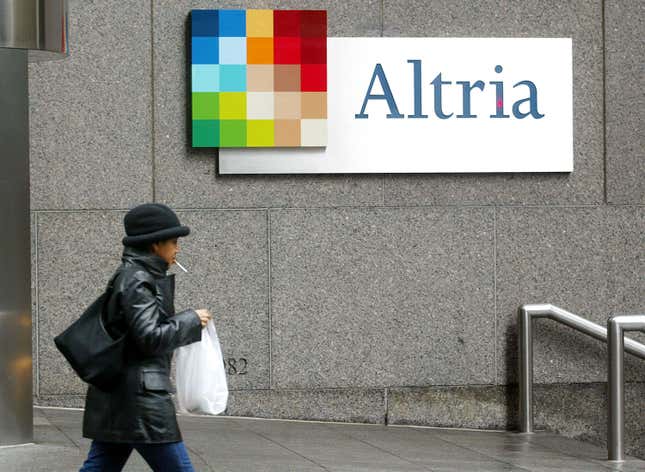 smoker walks past Altria signage