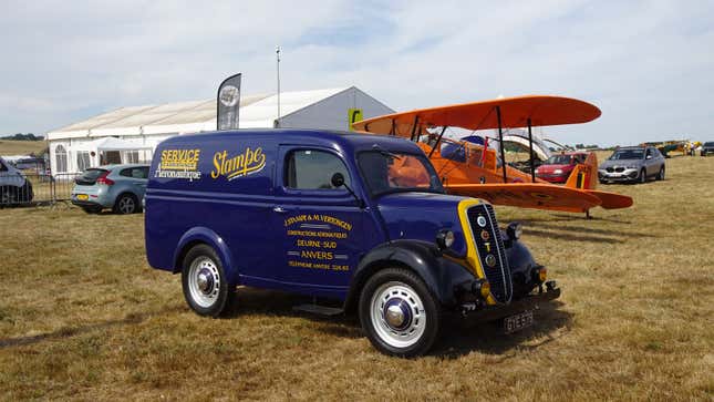 A photo of a vintage blue and yellow Fordson van.