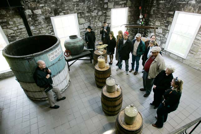 FILE - In this photo taken on April 8, 2009, guide Dave Salyers describes the bourbon making process to a group touring the Woodford Reserve distillery in Versailles, Ky. The Kentucky distillery has been ordered to bargain with a local Teamsters union after a federal labor law judge ruled that the prominent bourbon producer undermined efforts by its worker to unionize. (AP Photo/Ed Reinke, file)