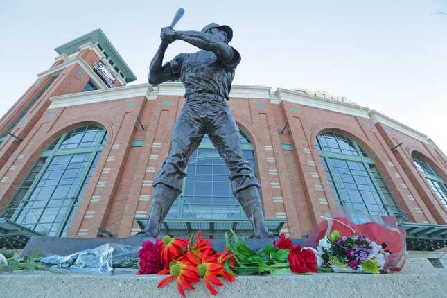 Flowers and momentous are laid at a makeshift memorial in front of the Henry Aaron statue at American Family Field Saturday, Jan. 23, 2021 in Milwaukee. Aaron, who began and ended his big-league career in Milwaukee and was known as \&quot;Hammerin&#39; Hank\&quot; for his successful pursuit of Babe Ruth&#39;s cherished home run record, died early Friday, Jan. 22, 2021 in his sleep at age 86. American Family Field 10