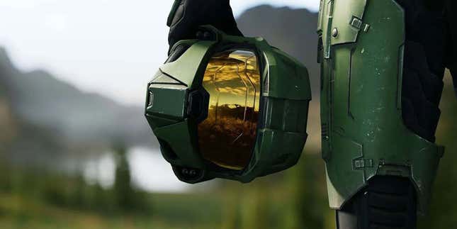 Master Chief holds his helmet.