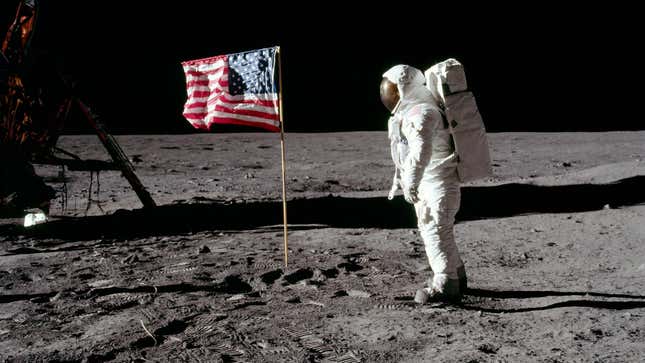 Astronaut Buzz Aldrin posing next to the American flag on the lunar surface