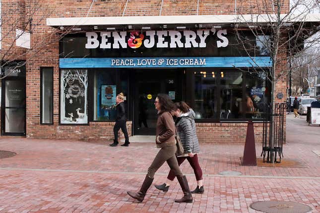 FILE - Pedestrians walk on Church St., past the Ben &amp; Jerry&#39;s shop, in Burlington, Vt., Wednesday, March 11, 2020. Unilever, the company that makes Ben &amp; Jerry’s ice cream, Dove soaps and Vaseline, said Tuesday, March 19, 2024, that it is cutting 7,500 jobs and spinning off its ice cream business to reduce costs and boost profits. (AP Photo/Charles Krupa, File)