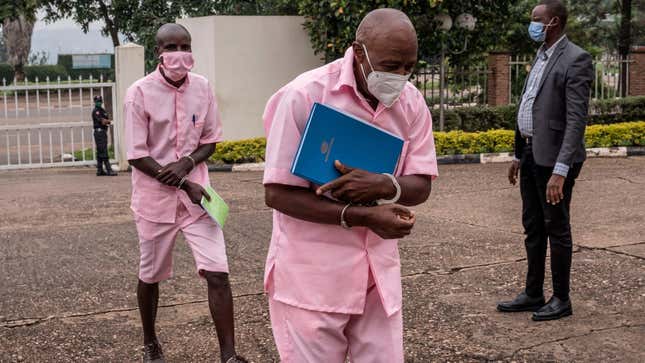 Paul Rusesabagina, center, arrives at the Supreme Court in Kigali on February 17, 2021 where he is facing charges related to their association with Mouvement Rwandais pour le changement démocratique (MRCD) and its armed wing FLN.