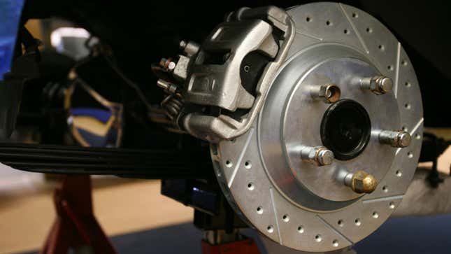 A close up photo of a disc brake on a car. 