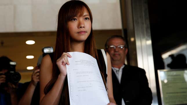Democratically-elected legislators Yau Wai-ching holds the judgement as she leaves the High Court after the ruling on Nov.15 court rules pro-independence lawmakers barred in Hong Kong, China November 15, 2016. REUTERS/Tyrone Siu - RTX2TPNW
