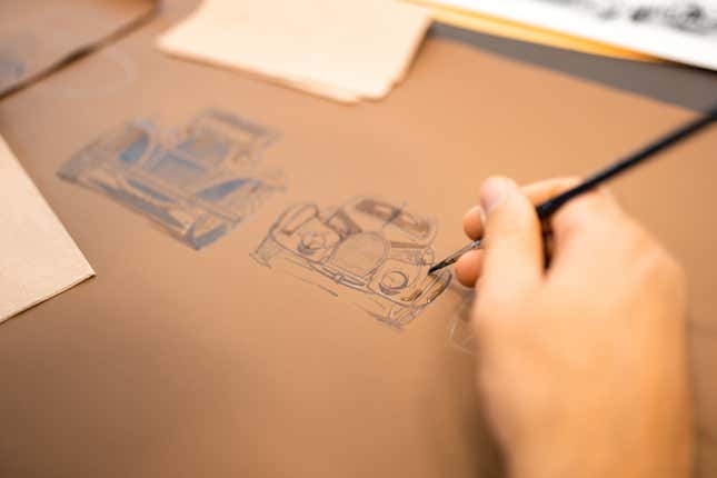 A designer painting the leather of the Bugatti Chiron Golden Era