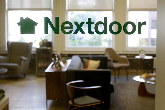 FILE - A Nextdoor sign is shown in a window at an office in San Francisco, May 11, 2016. Nextdoor is laying off 25% of its full-time staff as the neighborhood-focused social network company works to cut costs. The job eliminations are part of a larger cost reduction plan that aims to slash Nextdoor’s current personnel expenses by up to $60 million annually, according to a third-quarter financial report from the company. (AP Photo/Jeff Chiu, File)