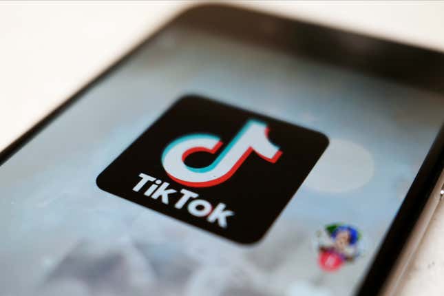 FILE - The TikTok logo is displayed on a smartphone screen, Sept. 28, 2020, in Tokyo, Japan. The European Union is looking into whether TikTok has broken the bloc’s strict new digital rules for cleaning up social media and keeping internet users safe. (AP Photo/Kiichiro Sato, File)