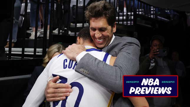 Steph Curry hugs general manager Bob Myers after a Golden State Warriors playoff win