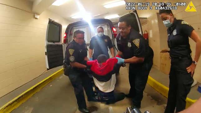 In this image taken from police body camera video provided by New Haven, Conn., Police, Richard “Randy” Cox, center, is pulled from the back of a police van and placed in a wheelchair after being detained by New Haven Police on June 19, 2022, in New Haven, Conn. 