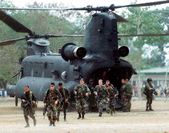U.S. Green Beret soldiers walk from their MH-47E helicopter uponarriving in Zamboanga, southern Philippines in 2002.