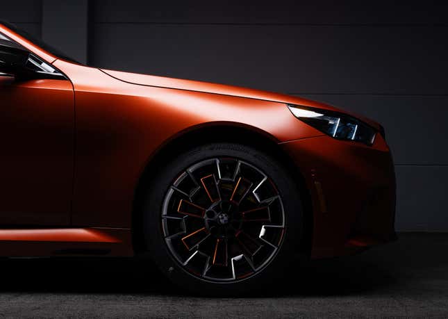 Front wheel of a matte orange 2025 BMW M5