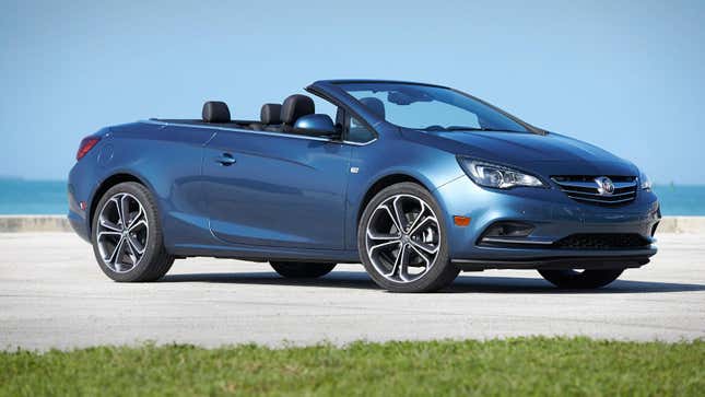 A blue Buick Cascada parked with the top down on the beach