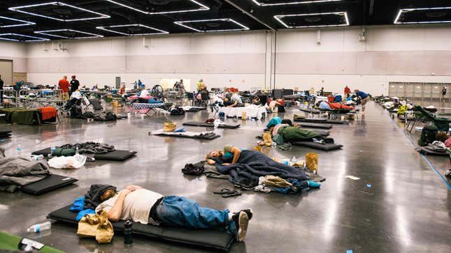 People rest at the Oregon Convention Center cooling station in Oregon, Portland on June 28, 2021, as a heatwave moves over much of the United States.
