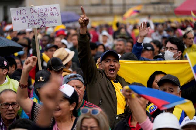 Anti-government demonstrators march to protest economic and social reforms pushed by the government of President Gustavo Petro and his proposal to convene a constituent assembly in Bogota, Colombia, Sunday, April 21, 2024. (AP Photo/Fernando Vergara)