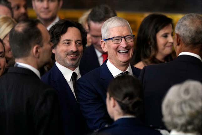 Apple CEO Tim Cook laughs during the inauguration of President Donald Trump on January 20, 2025.