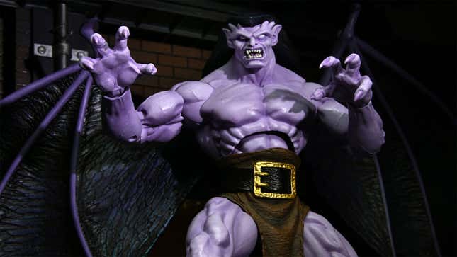 An image of NECA's highly-detailed Gargoyles Goliath action figure, purple with claws and wings and an angry face. 