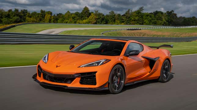 Front 3/4 view of a 2024 Chevrolet Corvette Z06 in Amplify Orange Tintcoat driving on a track.