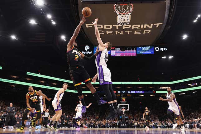 PHOENIX, ARIZONA - JANUARY 16: Josh Okogie #2 of the Phoenix Suns puts up a shot over Domantas Sabonis #10 of the Sacramento Kings during the first half of the NBA game at Footprint Center on January 16, 2024 in Phoenix, Arizona. The Suns defeated the Kings 119-117. NOTE TO USER: User expressly acknowledges and agrees that, by downloading and or using this photograph, User is consenting to the terms and conditions of the Getty Images License Agreement.  (Photo by Christian Petersen/Getty Images)