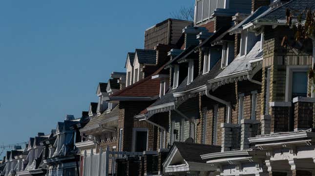 A row of terraced houses with a blue sky background.