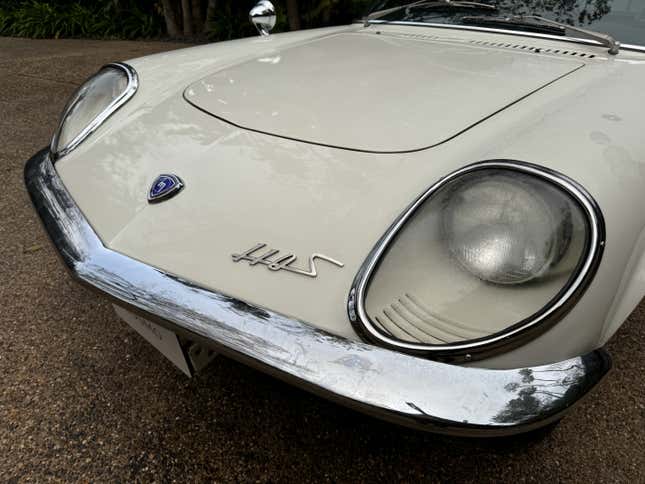 Detail photo of the front end of a white Mazda Cosmo 110S