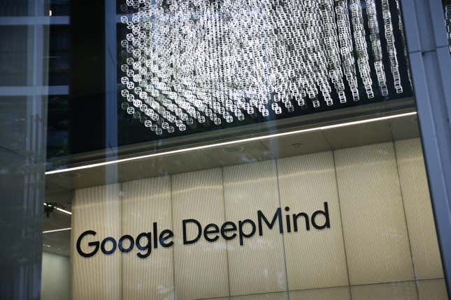 google deepmind logo on the wall of a building through a glass window