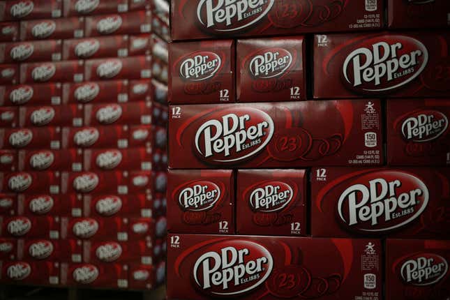 Cases of Dr. Pepper brand soda sit stacked in a warehouse at the Dr. Pepper Snapple Group Inc. bottling plant in Irving, Texas.